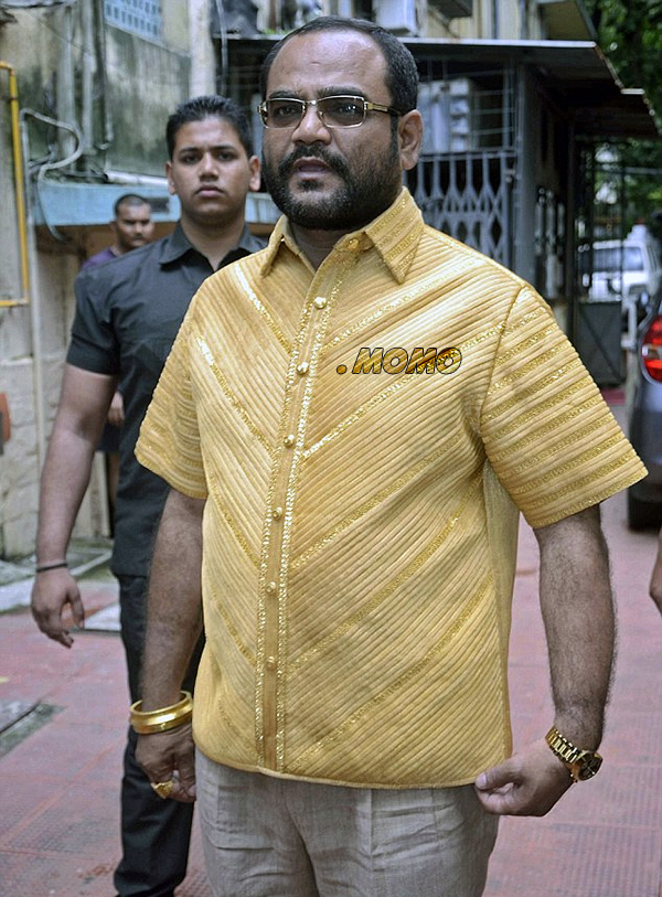 Puranjay Raja Bibek sporting a gold shirt and the dot .Momo gTLD.